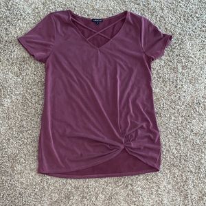 Cute burgundy blouse with cross pattern on top and twisted knot at the bottom